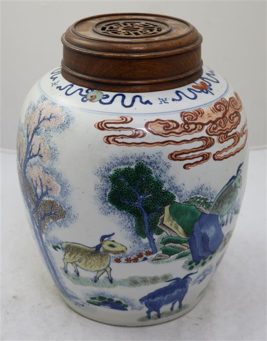 A large Chinese wucai ovoid jar, 19th century, height 27.5cm, rosewood cover and stand, crack to base